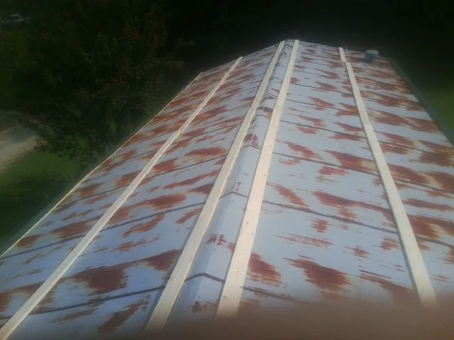 Rusted metal roof panels with new wood purlins before replacement — Storm Damage Roof Repair in Gazelle by Roofing Brothers