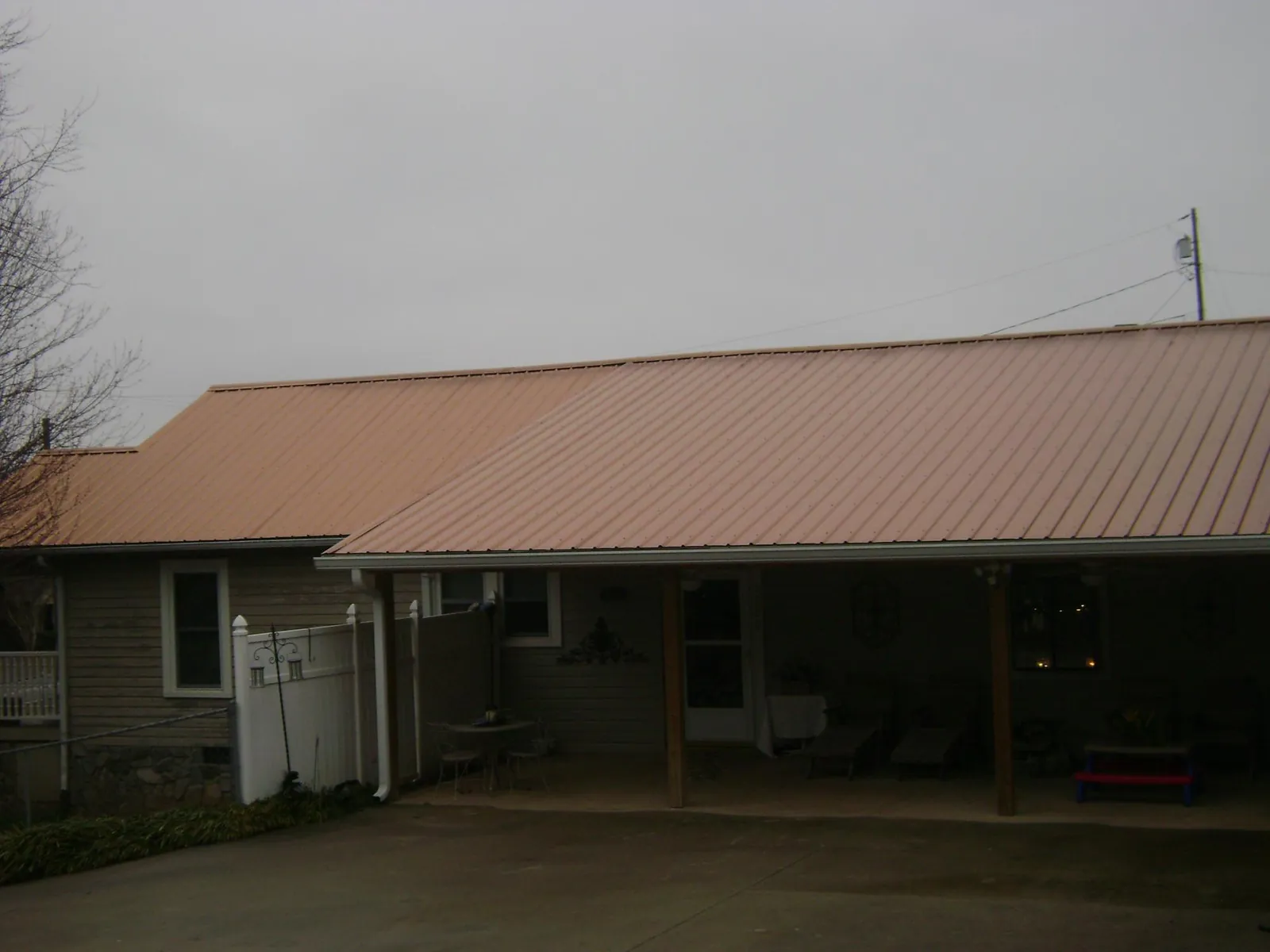 Copper toned metal roof over a wide covered patio in Gazelle